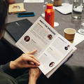 A closeup of someone at a conference reading the event brochure