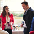 A man and woman talking during a conference break