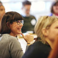 A woman smiling during a masterclass conference session