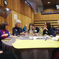 Conference attendees sat around a table in discussion