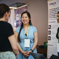 event attendees talking to a startup at their stand