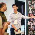 a startup founder stood at their stand talking to event attendees