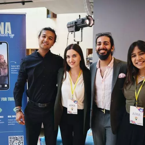 A startup team posing for a photo at their stand