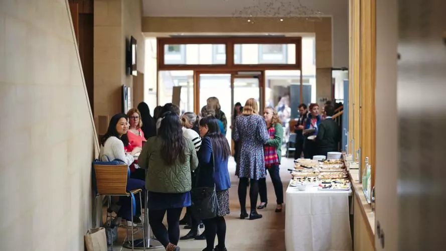 Conference attendees networking during a break