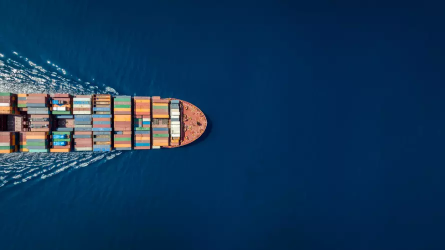 a dron picture of a half of a cargo shipon the left side