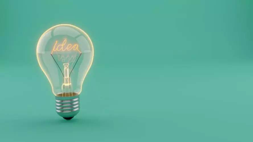 A lightbulb on a plain blue background with the word 'idea' spelt out as filament