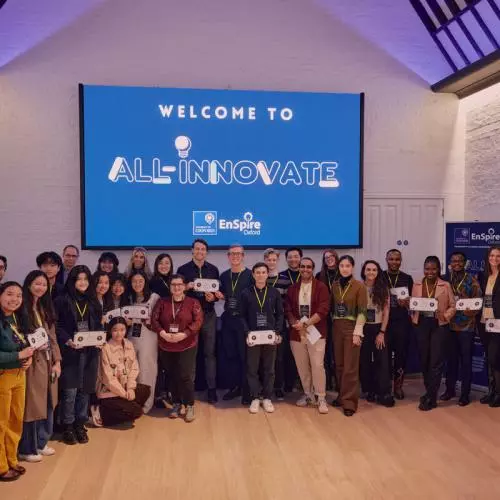 A group of early stage entrepreneurs smiling in a group at a startup event