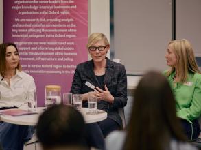 Three panellists in deep discussion during an event