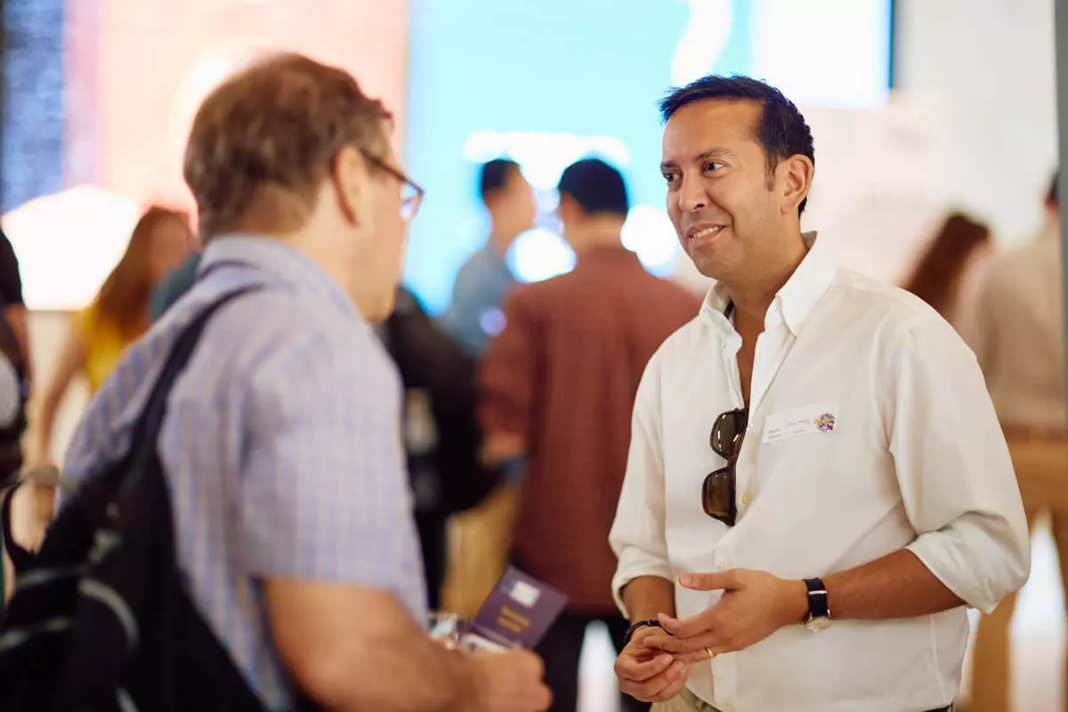 Two men talking at an event