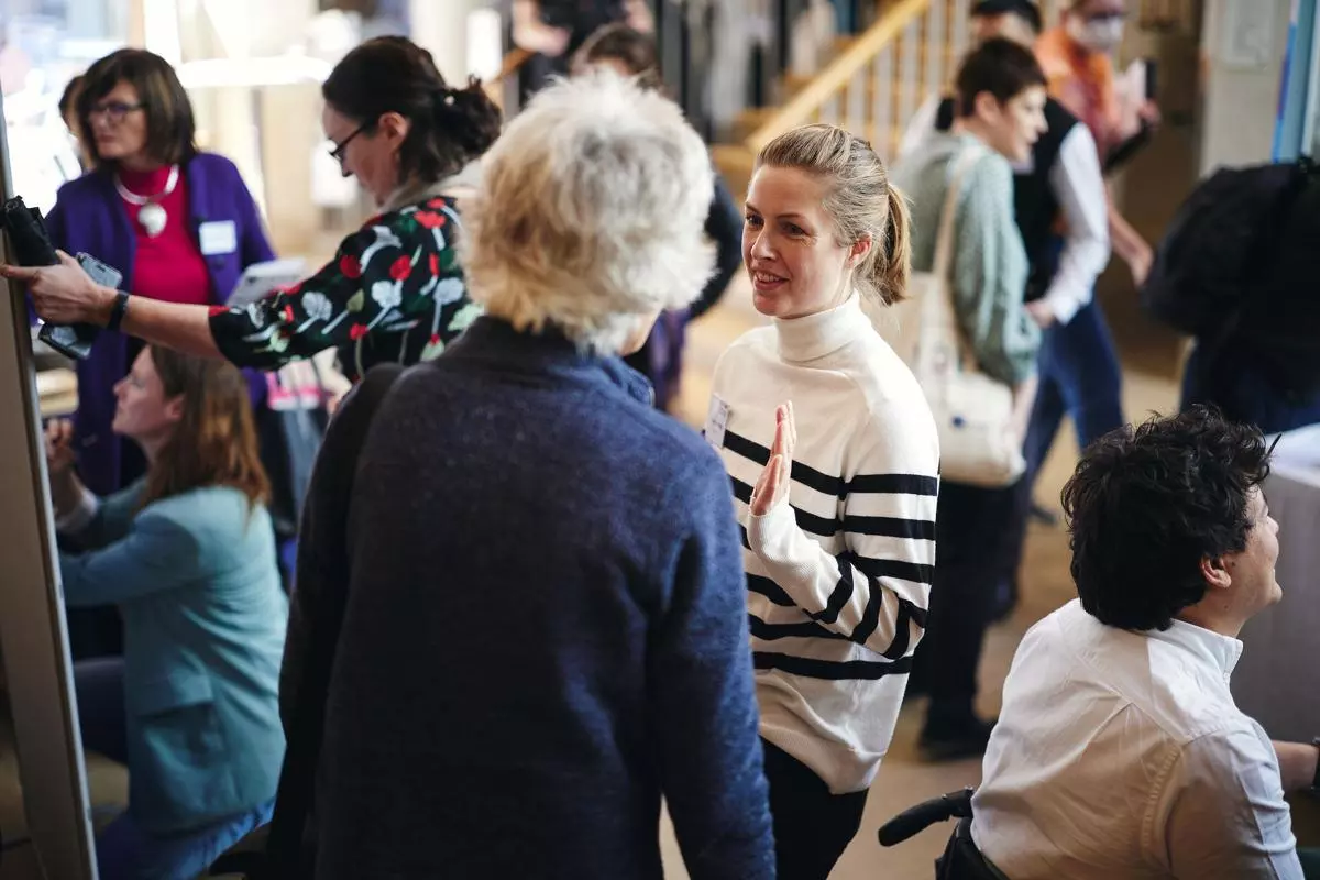 A group of people networking during a conference break